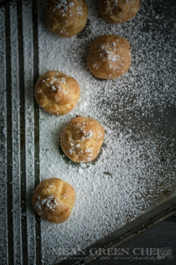 Pate a Choux Pastry dusted with powdered sugar with symmetrical vertical lines.