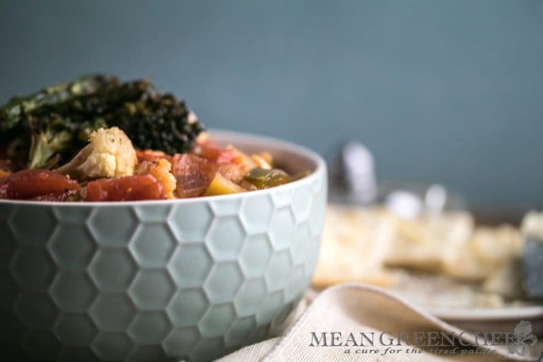 Side photo of a honeycomb pattern blue bowl filled with Hearty Vegetable Soup, Mean Green Chef.