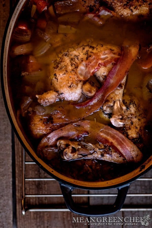 Coq Au Vin cooked in a gray Dutch Oven