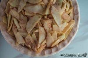 Slices of apples coated with apple pie spice for Caramel Apple Pie. Mean Green Chef