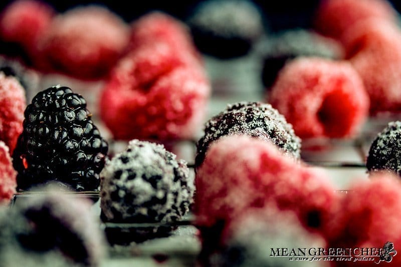 Sugared Blackberries and raspberries drying on a baking rack.