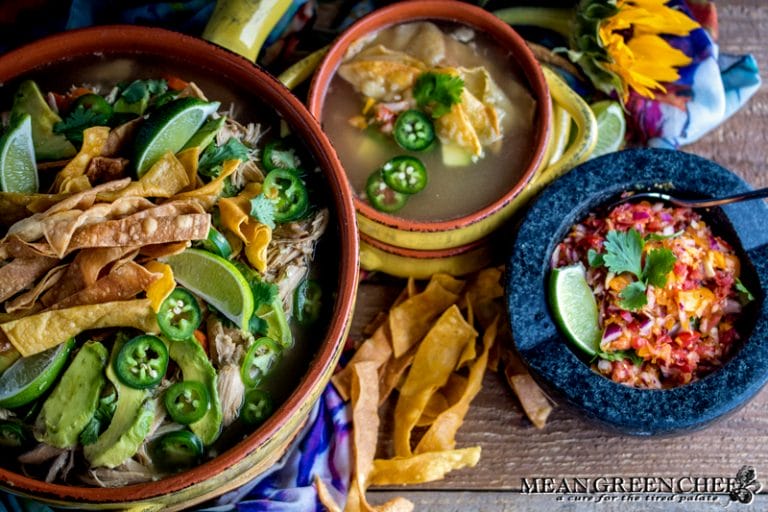 Overhead photo of Mexican Tortilla Chicken Soup Recipe in terracotta pot and bowls with crispy tortilla strips