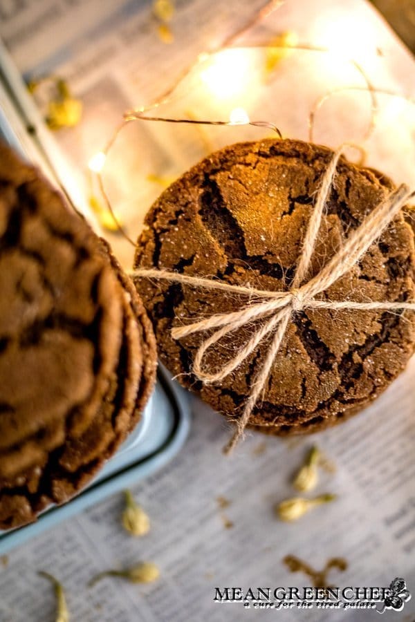 Overhead photo of a stack of Molasses Cookies, tied with twine and sitting on newspaper