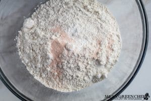 Ingredients for Bakery Style Chocolate Chip Cookies in a large glass bowl.