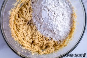 Ingredients for Bakery Style Chocolate Chip Cookies in a large glass bowl.