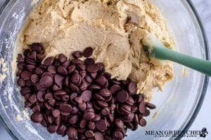 Ingredients for Bakery Style Chocolate Chip Cookies in a large glass bowl.