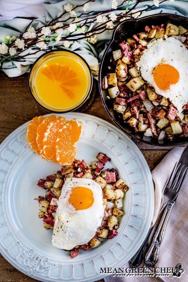 Overhead shot of Restaurant Style Corned Beef Hash topped with sunny side up eggs.