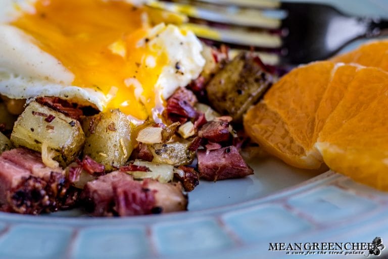 Overhead shot of Restaurant Style Corned Beef Hash topped with sunny side up eggs.