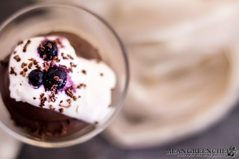 Overhead shot of Rich Chocolate Creme Patissiere Pastry Cream topped with whipped cream and blueberries.