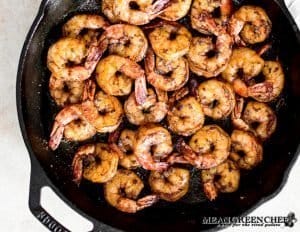 Blackened Shrimp cooking in a cast iron skillet.