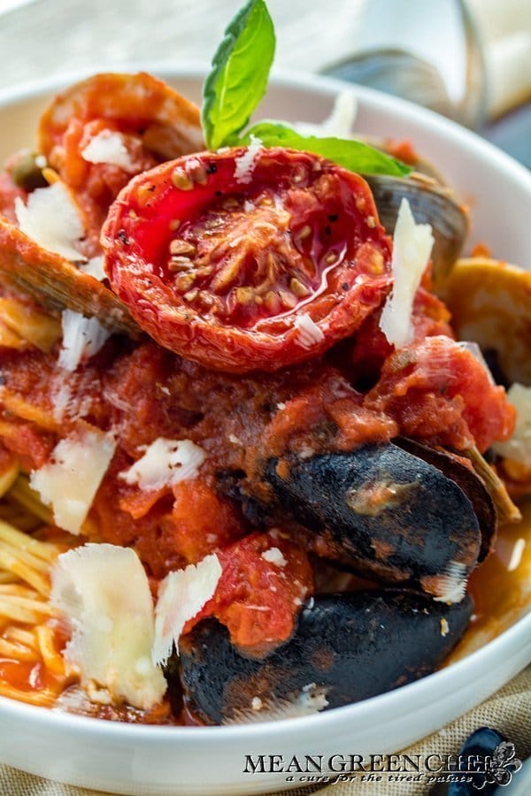 Bowl of Pasta Pescatore served up with a sweet slow roasted tomato.