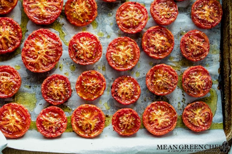 Slow Roasted Tomatoes on a sheet pan lined with parchment paper.