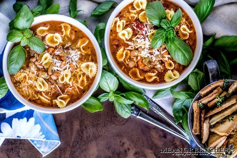 Two bowls of Pasta e Fagioli with crackers.