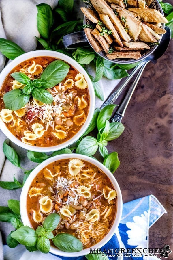 Two bowls of Pasta e Fagioli with crackers.