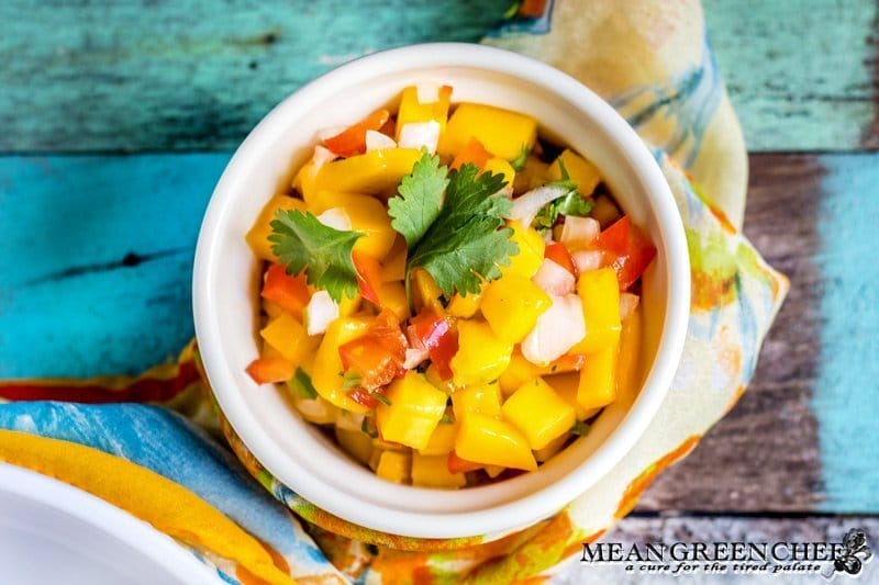 Fresh Mango Salsa in a bowl with an old blue board background.
