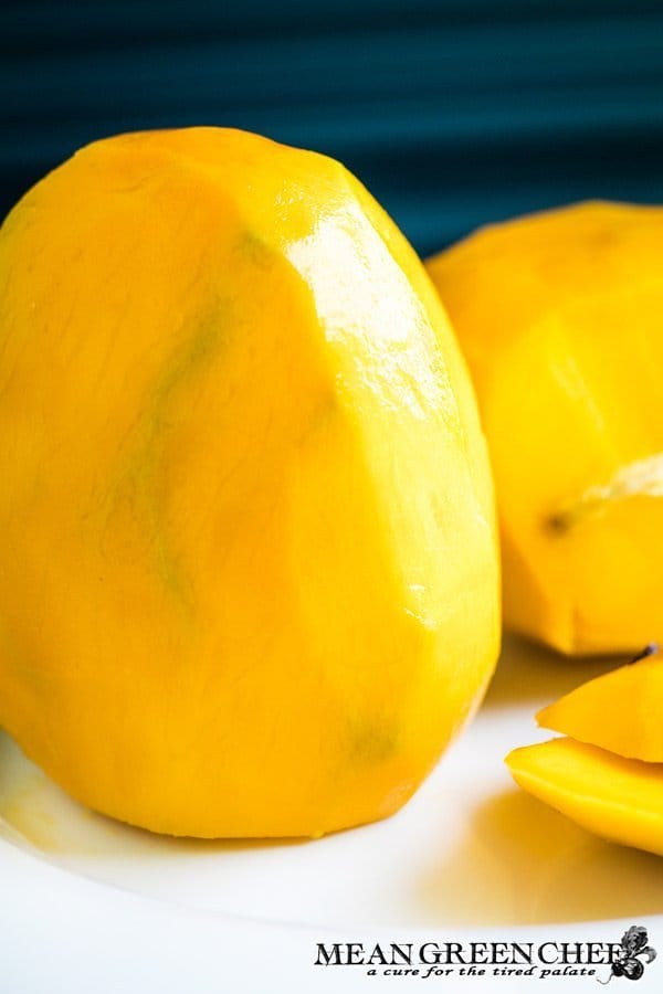 mango standing on end waiting to be cut.