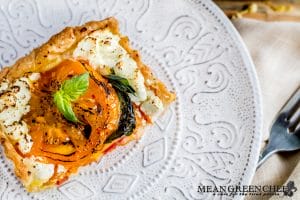 Plated heirloom Tomato Tart on an off white plate