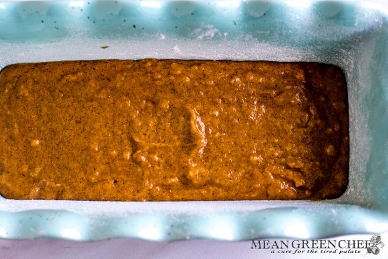 Batter in a blue loaf pan for Pumpkin Cream Cheese Bread