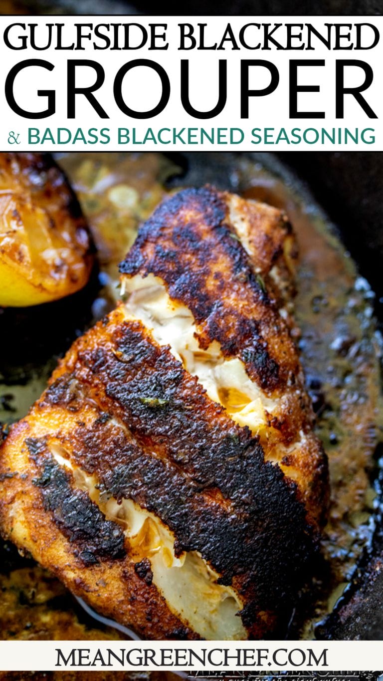 Pinterest Pin Image, Closeup of pan-seared Gulfside Blackened Grouper with a crispy blackened crust in a cast iron skillet, with a half grilled lemon on the left-hand side.